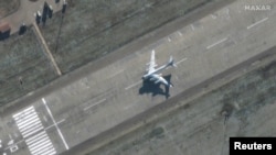 A satellite image shows a bomber preparing to take off at Engels Air Base in Saratov, Russia. Taken December 3, 2022