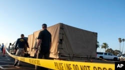 FBI investigators unload equipment to begin examining evidence obtained from the wreckage of the dive boat Conception on Sept. 4, 2019, in Santa Barbara, Calif.