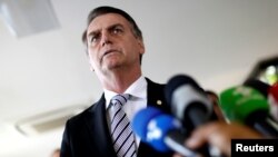 Brazil's President-elect Jair Bolsonaro talks to the media, in Brasilia, Brazil, Nov. 7, 2018. 