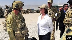 Australian Prime Minister Julia Gillard, center, meets Corporal Craig Turnball and his Explosive Detection Dog during her visit at Multinational Base Tarin Kot in southern Afghanistan, 02 Oct. 2010