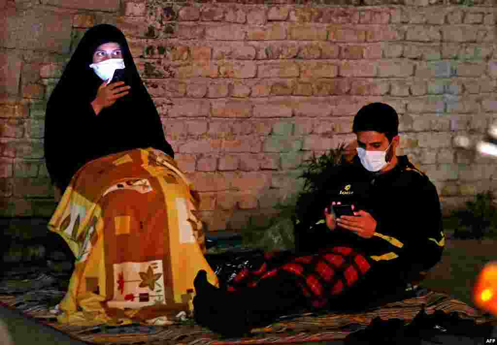 Iranians attends Laylat al-Qadr prayers, one of the holiest nights during the Muslim fasting month of Ramadan, outside a mosque in the Tehran.