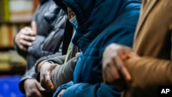 Members of the Masjid Ar Rahman pray, in the Bronx borough of New York, Jan. 12, 2022. The mosque is a place of worship for some of the residents of the building, site of New York City's deadliest fire in three decades.