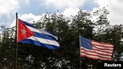 FILE - Flags of Cuba and the U.S. flutter in Havana, Cuba, Dec. 19, 2014. 