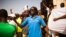 FILE - A man shouts as he and others gather at the Place de Nation calling for a civilian democratic transition in Ouagadougou, Burkina Faso, Nov. 2, 2014.
