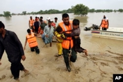FILE - Army evacuates people from a flood-hit area in Rajanpur, district of Punjab, Pakistan, Aug. 27, 2022.