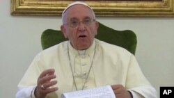 Pope Francis gives a recorded message for the soccer World Cup: 'Let football be a showcase for teamwork and solidarity, not an exhibition of racism and greed,' June 12, 2014.