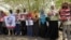Journalists carry signs demanding freedom of press and expression during a demonstration against the violations of the security services towards the press and journalists outside the Council of the Press and Publication, in Khartoum, Sudan, May 16, 2012.