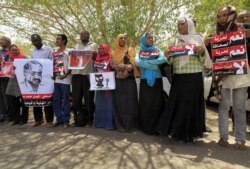 FILE - Journalists carry signs demanding freedom of expression during a protest against security services' actions toward journalists in Khartoum, Sudan, May 16, 2012. Recent hopes for a freer press in the country have dissipated.