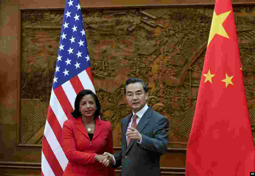 U.S. National Security Adviser Susan Rice shakes the hand of Chinese Foreign Minister Wang Yi at the Olive Hall before a meeting at the Foreign Ministry office, in Beijing, Sept. 9, 2014.