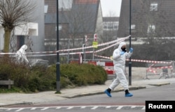 Forensic officers investigate the area at the scene of an explosion at a coronavirus testing location in Bovenkarspel, near Amsterdam, Netherlands, March 3, 2021.