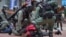 FILE - Riot police detain a protester during a demonstration against Beijing's national security legislation in Causeway Bay in Hong Kong on May 24, 2020. Hong Kong began work on a local National Security Law on Jan. 30, 2024.