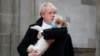 Britain&#39;s Prime Minister and Conservative Party leader Boris Johnson holds his dog Dilyn as he leaves after voting in the general election at Methodist Central Hall, Westminster, London.