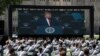 A screen displays President Donald Trump as he speaks to over 1,110 cadets in the Class of 2020 at a commencement ceremony on the parade field, at the United States Military Academy in West Point, N.Y., June 13, 2020.