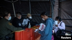 FILE - Roberto, 37, from Honduras, has his family's court dates changed by Customs and Border Protection after court cancellations amid the coronavirus disease (COVID-19) outbreak in Ciudad Juarez, Mexico, April 20, 2020.