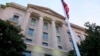 FILE - A May 14, 2013 file photo shows the Department of Justice headquarters building in Washington. The Justice Department has reached a $134,000 settlement with a New York woman after federal drug agents used information from her cellphone to set up a…