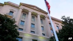 FILE - A May 14, 2013 file photo shows the Department of Justice headquarters building in Washington. The Justice Department has reached a $134,000 settlement with a New York woman after federal drug agents used information from her cellphone to set up a…