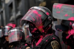 Riot police get covered in red paint by abortion-rights demonstrators during the "Day for Decriminalization of Abortion in Latin America and the Caribbean" march in Mexico City, Sept. 28, 2020.