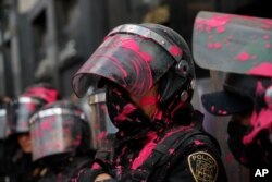 Riot police get covered in red paint by abortion-rights demonstrators during the "Day for Decriminalization of Abortion in Latin America and the Caribbean" march in Mexico City, Sept. 28, 2020.
