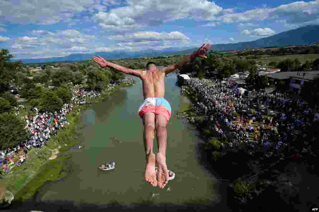 A diver jumps from the 22-meter-high bridge &quot;Ura e Shenjte&quot; near the town of Gjakova, Kosovo, as a sign of protest after police canceled the 70th traditional annual High Diving competition due to spectators failing to keep social distancing rules.