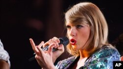 FILE - Singer Taylor Swift performs during her "1989" world tour at MetLife Stadium, July 11, 2015.