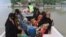 Pakistani volunteers rescue villagers from a flooded area in Layyah, Pakistan, July 25, 2015. 
