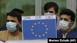 In this Friday, April 30, 2021, photo former Afghan interpreters hold placards during a protest against the U.S. government and NATO in Kabul, Afghanistan. (AP Photo/Mariam Zuhaib)