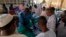 Officer delivers passports to migrants at the Secretariat for Sudanese Working Abroad, Khartoum, May 13, 2013.