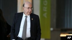 FILE - Henrique Meirelles, minister of finance of Brazil, arrives for the official group picture during a G-20 finance ministers and central bankers summit in Buenos Aires, Argentina, March 19, 2018.