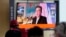 FILE - People watch a TV screen showing an image of North Korean leader Kim Jong Un during a news program at the Seoul Railway Station in Seoul, South Korea, Oct. 12, 2021. 
