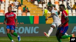 Senegal's Lamine Camara, center, shoots the ball to score his side's second goal during the African Cup of Nations Group C soccer match against Gambia at the Charles Konan Banny stadium in Yamoussoukro, Ivory Coast, Jan. 15, 2024.