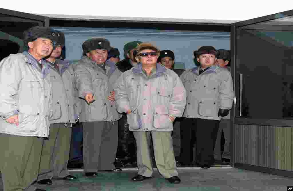 North Korean leader Kim Jong Il (C), accompanied by his son Kim Jong Un (R), inspecting Korean People's Army Air Force Unit 1016 honored with the title of O Jung Hup-led Seventh Regiment at undisclosed place in North Korea, undated handout picture. (AFP)