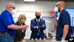 President Joe Biden and first lady Jill Biden tour an HVAC workshop at Tidewater Community College, May 3, 2021, in Portsmouth, Va. Harlan "Skip" Krepcik, who teaches about heating, ventilation and air-conditioning systems, is at left. 