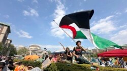 Seorang demonstran mengibarkan bendera Palestina dalam aksi protes di area kampus Columbia University di New York, pada 29 April 2024. (Foto: AP/Ted Shaffrey)