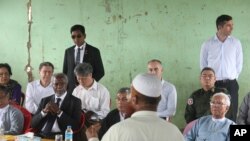 Former United Nations Secretary-General Kofi Annan, second left, listens to a Rohingya religious and community leader as he is explained the situation in the Internally Displaced People's camps as the Rakhine Advisory Commission visits a camp in Thetkabyin village, outside Sittwe, the capital of Rakhine state.