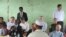 Former United Nations Secretary-General Kofi Annan, second left, listens to a Rohingya religious and community leader as he is explained the situation in the Internally Displaced People's camps as the Rakhine Advisory Commission visits a camp in Thetkabyin village, outside Sittwe, the capital of Rakhine state.
