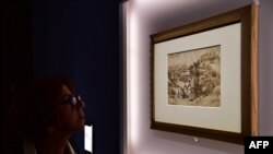 FILE - A visitor looks at a landscape by Italian master Leonardo Da Vinci presented at the Palazzo Reale museum as part of the exhibition 'Leonardo Da Vinci,' in Milan, Italy.