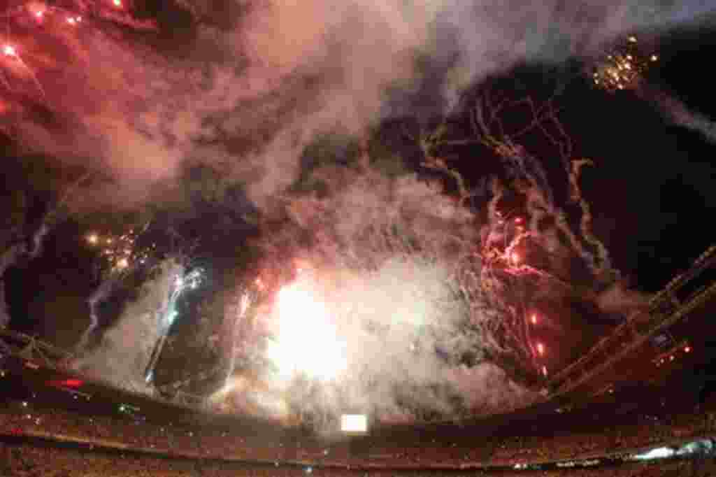 Fireworks are seen over the Metropolitan stadium during the opening ceremony of the U-20 World Cup soccer championship in Barranquilla, Colombia, Friday, July 29, 2011. (AP Photo/Fernando Llano)