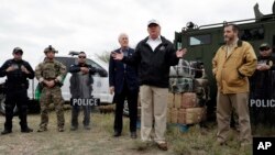 FILE - President Donald Trump speaks as tours the U.S. border with Mexico at the Rio Grande on the southern border, Jan. 10, 2019, in McAllen, Texas, as Sen. John Cornyn, R-Texas, left, and Sen. Ted Cruz, R-Texas, listen.