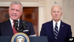 FILE - Jordan's King Abdullah II speaks as President Joe Biden listens in the Cross Hall of the White House, February 12, 2024, in Washington. 