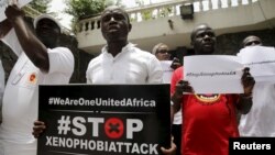 People protesting against xenophobia in South Africa hold placards in front of the South African consulate in Lagos, April 16, 2015. 