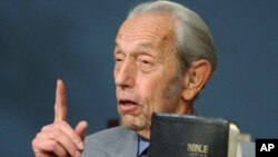 In this Dec. 12, 2002 file photo, Harold Camping speaks while holding the Bible, in San Leandro, Calif.