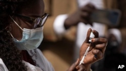 FILE: Healthcare worker prepares a dose of COVID-19 vaccine for injection, Dakar, Senegal, February 23, 2021