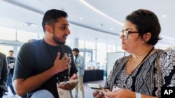 FILE - Tarjimly co-founder Atif Javed talks to attendee Lauren Welke astir  Tarjimly astatine  the Google Impact Summit connected  Sept. 4, 2024, successful  Sunnyvale, Calif.