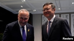 U.S. Senate Majority Leader Chuck Schumer poses with Shanghai Party Secretary Chen Jining in Shanghai on Oct. 7, 2023. 