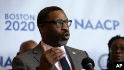 In this Thursday, Dec. 12, 2019 file photo, National Association for the Advancement of Colored People President Derrick Johnson faces reporters during a news conference in Boston.