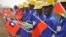 FILE - Students at the vocational training center of reference (Centre de formation professionnelle de reference de Ziniare (CFPR-Z)) in Ziniare, 35kms of Ouagadougou hold Taiwan's and Burkina Faso's flags during the visit of Taiwan's President on April 9
