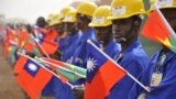 FILE - Students at the vocational training center of reference (Centre de formation professionnelle de reference de Ziniare (CFPR-Z)) in Ziniare, 35kms of Ouagadougou hold Taiwan's and Burkina Faso's flags during the visit of Taiwan's President on April 9