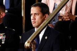 FILE - The leader of Venezuela's political opposition Juan Guaido makes a speech at the Madrid regional government building during a visit to Madrid, Spain, Jan. 25, 2020.