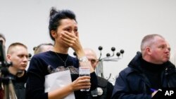 A Ukrainian International Airline company worker reacts during a briefing at Borispil international airport outside Kyiv, Ukraine, Jan. 8, 2020.