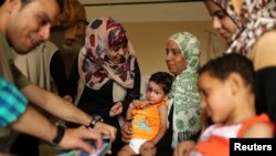 Mohammed Wahdan, wounded in Israeli shelling, receives psychological care at Shifa hospital in Gaza City ,August 14, 2014.